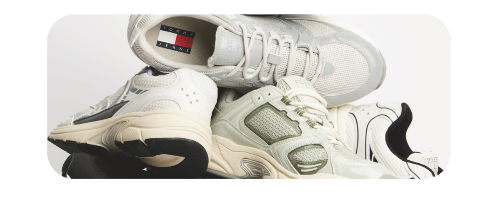 A collection of chunky Tommy Jeans sneakers in white and grey tones.